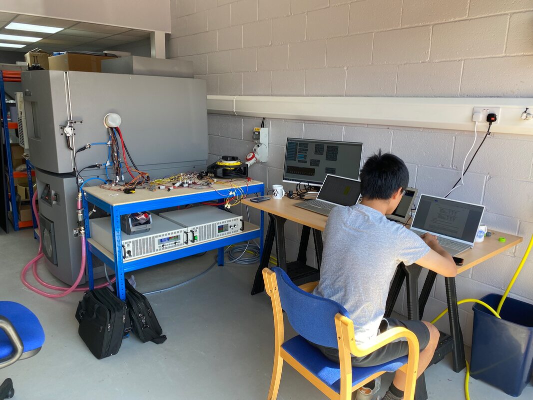 Thermal chamber, temperature regulated coolant, load bank and power supply for high power pulse testing of batteries